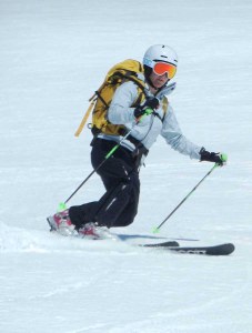 Suzanne telemark touring in Kuhtai, Austria, with a pack on her back.