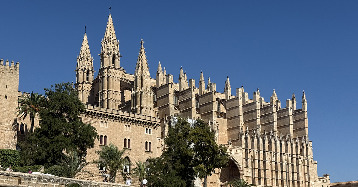 Palma cathedral with pointy spires against a clear blue sky